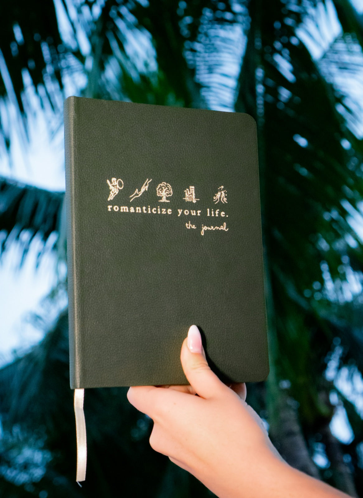 Stylish shot of the Romanticize Your Life Journal on a desk with tea.